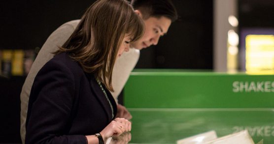 Two people looking in a display case