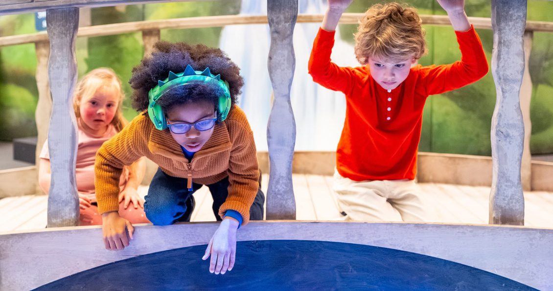 An image of three children inside the British Library's Fairy Tales exhibition