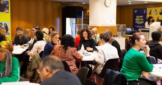 A room full of adults participating in a workshop