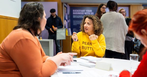 People in discussion, they are sat around a round table