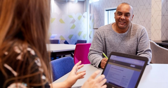 A man and a woman talk at a business centre (BIPC) in Brighton Library.