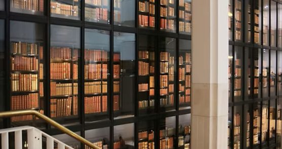 Books on shelves behind glass at the British Library