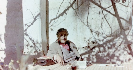 An elderly woman sat at a table
