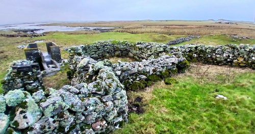 image shows ruined abandoned stone house