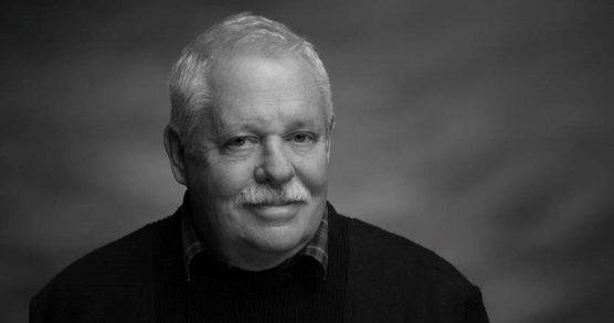 Black and white Photo of a man smiling at the camera