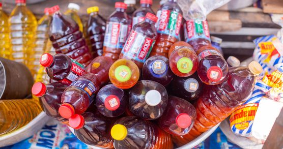 Bottled palm oil in a pan at the market