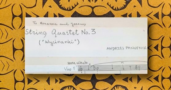 Image of the top of the first page of the manuscript of Panufnik's third string quartet, showing the title and dedication to his children. In the background, a strip-style paper cutout from the Lublin region.