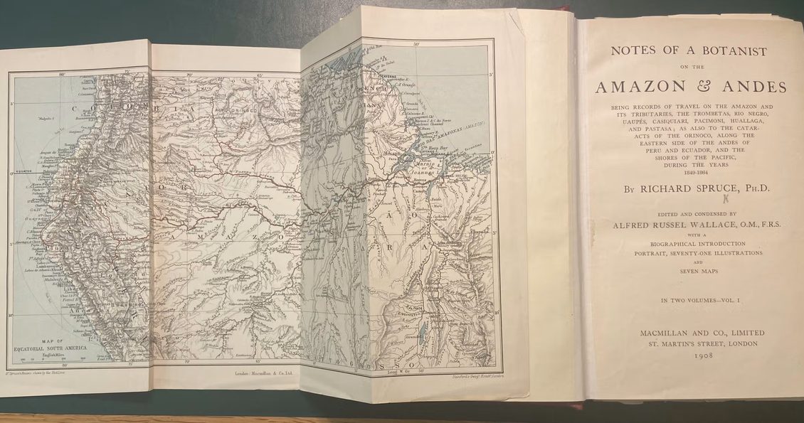 Book open at the title page with a large fold-out map of the Amazon also open.