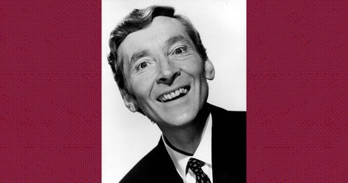 Monochrome photograph of Kenneth Williams smiling