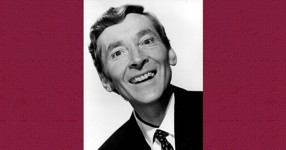 Monochrome photograph of Kenneth Williams smiling