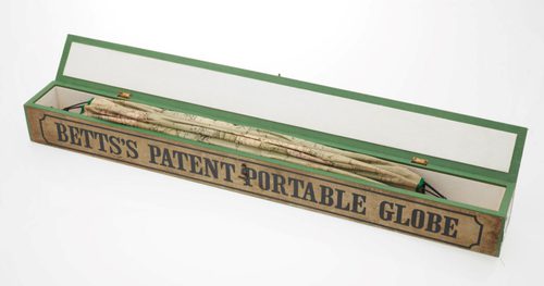 A long, thin box containing folded paper. Text on the outside of the box reads Betts's portable terrestrial globe.