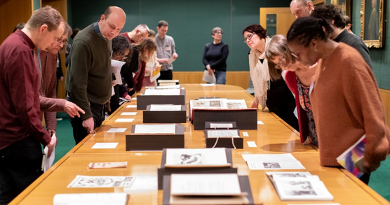 People looking at collection items on a table