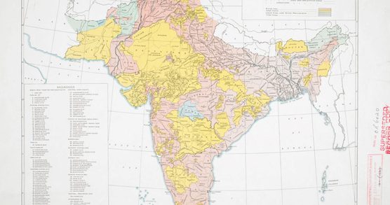 A 1940s map of India with different areas colour coded in pale pink, yellow and green.
