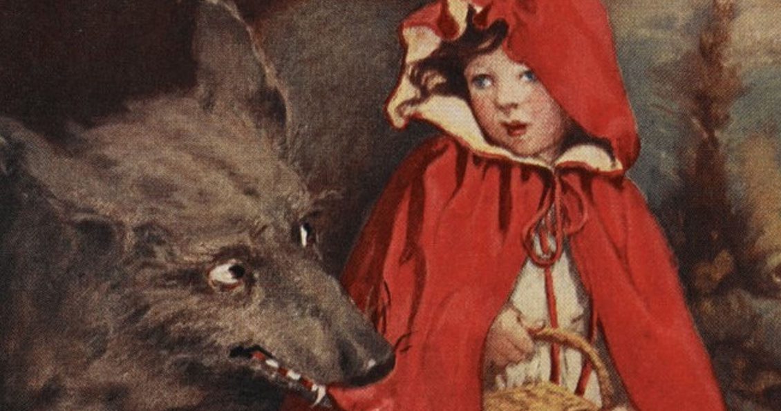 An illustration of a girl wearing a red cape with a hood, holding a picnic basket and looking over her shoulder at a black wolf with it's fang and tongue exposed.