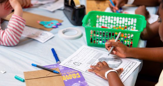 Children using crafting materials at a table