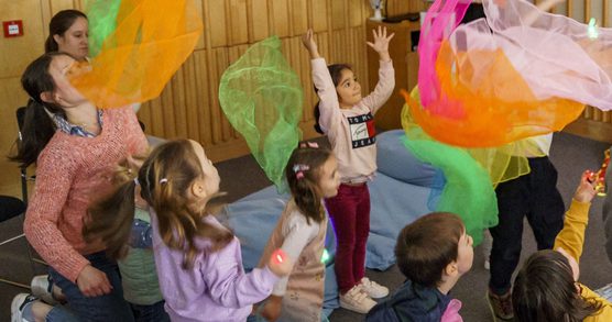 Children playing with coloured scarves