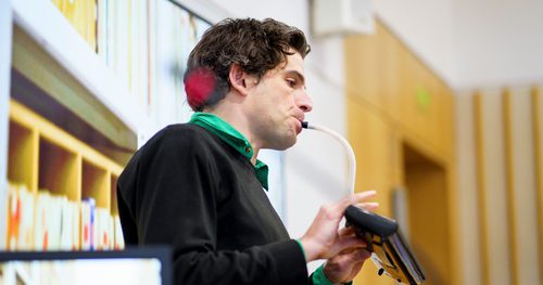 Storyteller and Musician Paul playing a portable organ