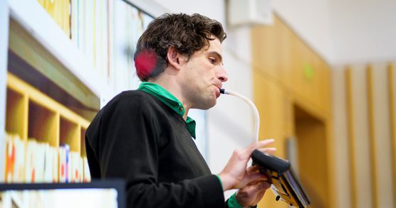 Storyteller and Musician Paul playing a portable organ